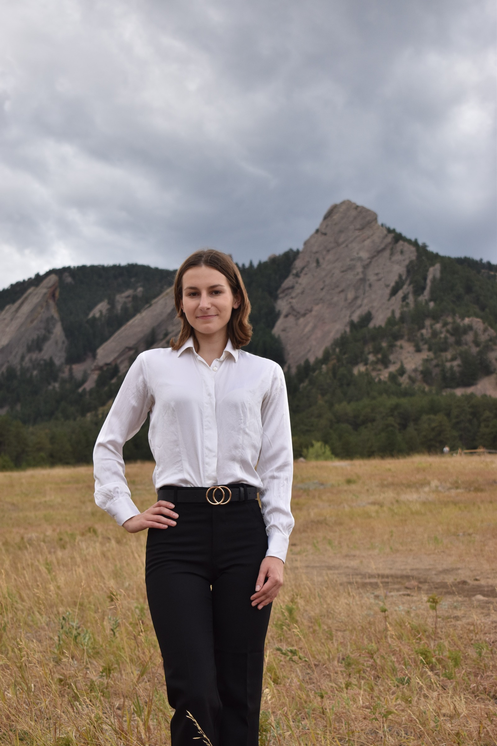 Amanda Stevens standing in front of the Boulder Flatirons